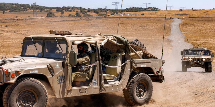 Israeli army humvee vehicles move during a military drill in a special designed exercise area in the Israeli-annexed Golan Heights on July 8, 2025. (Photo by Jalaa MAREY / AFP)